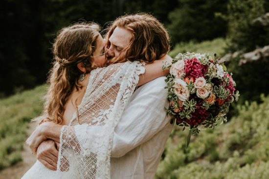 a bride and groom share a kiss during their Mt. Rainier adventure elopement